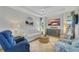 Relaxing living room with comfy seating, a large TV, and a calming coastal decor at 11467 Conch Ct, Venice, FL 34292