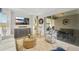 Bright living room featuring comfortable seating, large TV, and access to a patio at 11467 Conch Ct, Venice, FL 34292