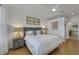 Main bedroom with king-size bed, ensuite bathroom, and calming decor at 11467 Conch Ct, Venice, FL 34292