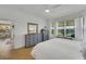 Bright bedroom with king-size bed, dresser, and access to the bathroom at 11467 Conch Ct, Venice, FL 34292