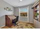 Home office with built-in shelving, roll top desk, and window with blinds at 11467 Conch Ct, Venice, FL 34292