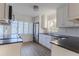 Updated kitchen with white cabinets, stainless steel appliances and hardwood floors at 116 23Rd W St, Bradenton, FL 34205