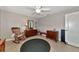 Cozy bedroom featuring a rocking chair, ceiling fan, and classic wood furniture at 1237 Flying Bridge Ln, Osprey, FL 34229