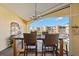 Waterfront balcony featuring a table and chairs for outdoor dining at 14041 Bellagio Way # 315, Osprey, FL 34229