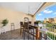Spacious balcony with granite-top table, chairs, and water views at 14041 Bellagio Way # 315, Osprey, FL 34229