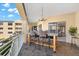 Outdoor balcony with a granite table and four bar stools at 14041 Bellagio Way # 315, Osprey, FL 34229