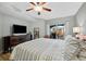 King bedroom with striped bedding and city views at 14041 Bellagio Way # 315, Osprey, FL 34229