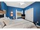 Guest bedroom with blue walls and striped bedding at 14041 Bellagio Way # 315, Osprey, FL 34229