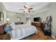 Main bedroom with striped bedding and wood dresser at 14041 Bellagio Way # 315, Osprey, FL 34229