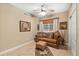 Cozy den featuring a brown couch and a ceiling fan at 14041 Bellagio Way # 315, Osprey, FL 34229