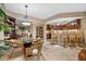 Bright dining area with a glass-top table and wicker chairs at 14041 Bellagio Way # 315, Osprey, FL 34229
