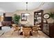 Elegant dining area with glass-top table and wine storage at 14041 Bellagio Way # 315, Osprey, FL 34229