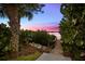 Wooden walkway to private dock at sunset at 14041 Bellagio Way # 315, Osprey, FL 34229