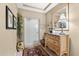 Elegant entryway with a wooden dresser and large mirror at 14041 Bellagio Way # 315, Osprey, FL 34229