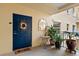 Inviting entryway with blue door, plants, and a welcome mat at 14041 Bellagio Way # 315, Osprey, FL 34229