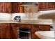 Well-equipped kitchen with stainless steel appliances and wood cabinets at 14041 Bellagio Way # 315, Osprey, FL 34229