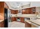 Well-equipped kitchen with stainless steel appliances and wood cabinets at 14041 Bellagio Way # 315, Osprey, FL 34229