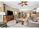 Comfortable living room featuring a large TV and ample seating at 14041 Bellagio Way # 315, Osprey, FL 34229