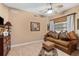 Comfortable living room with a sofa and a ceiling fan at 14041 Bellagio Way # 315, Osprey, FL 34229
