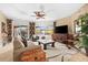 Spacious living room with large windows, leather sofa, and flat-screen TV at 14041 Bellagio Way # 315, Osprey, FL 34229