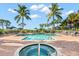 Resort-style pool and hot tub with lounge chairs at 14041 Bellagio Way # 315, Osprey, FL 34229