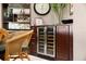 Built-in wine storage with glass door and wooden cabinets at 14041 Bellagio Way # 315, Osprey, FL 34229