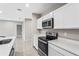 Modern kitchen with white cabinets and stainless steel appliances at 17020 11Th E Ter, Bradenton, FL 34212