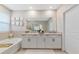 Modern bathroom with double vanity, granite countertop, and a soaking tub at 17633 Cantarina Cv, Bradenton, FL 34211