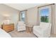 Bright bedroom sitting area with two comfy armchairs and a side table at 17633 Cantarina Cv, Bradenton, FL 34211