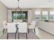 Bright dining area with modern light fixture and sliding doors at 17633 Cantarina Cv, Bradenton, FL 34211