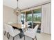 Dining room with glass-top table and sliding glass doors at 17633 Cantarina Cv, Bradenton, FL 34211