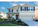 Two-story house with a two-car garage and landscaped yard at 17633 Cantarina Cv, Bradenton, FL 34211
