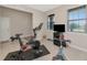 Home gym with Peloton bike and other exercise equipment at 17633 Cantarina Cv, Bradenton, FL 34211