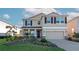 Two-story house with landscaping and a two-car garage at 17633 Cantarina Cv, Bradenton, FL 34211