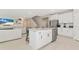 Modern kitchen with white cabinets, granite countertops, and stainless steel appliances at 17633 Cantarina Cv, Bradenton, FL 34211