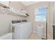 Laundry room with washer, dryer, and ample storage at 17633 Cantarina Cv, Bradenton, FL 34211