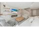 Open living space with a fireplace and built-in shelving at 17633 Cantarina Cv, Bradenton, FL 34211