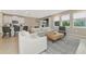 Spacious living room with a fireplace and large windows at 17633 Cantarina Cv, Bradenton, FL 34211