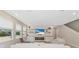 Bright living room with large windows and a fireplace at 17633 Cantarina Cv, Bradenton, FL 34211