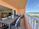Ocean view balcony with patio furniture, perfect for outdoor dining and relaxation at 1906 Gulf N Dr # 106, Bradenton Beach, FL 34217