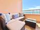 Relaxing balcony with ocean view and comfy seating at 1906 Gulf N Dr # 106, Bradenton Beach, FL 34217