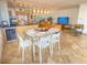 Modern glass dining table with white chairs, near kitchen at 1906 Gulf N Dr # 106, Bradenton Beach, FL 34217