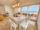 Elegant dining area with glass table and ocean views at 1906 Gulf N Dr # 106, Bradenton Beach, FL 34217