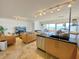 Combined kitchen and living area with ocean view, leather sofas, and modern finishes at 1906 Gulf N Dr # 106, Bradenton Beach, FL 34217