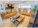 Open concept living area with modern coffee table and leather sofas at 1906 Gulf N Dr # 106, Bradenton Beach, FL 34217