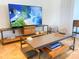 Living area features a large TV, coffee table, and modern decor at 1906 Gulf N Dr # 106, Bradenton Beach, FL 34217