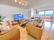 Bright living room boasts ocean views and comfortable leather sofas at 1906 Gulf N Dr # 106, Bradenton Beach, FL 34217