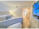 Bright bedroom with a king-size bed and access to a balcony at 1906 Gulf N Dr # 106, Bradenton Beach, FL 34217