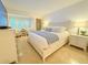 Spacious main bedroom with a king-size bed and beachy decor at 1906 Gulf N Dr # 106, Bradenton Beach, FL 34217