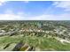Wide aerial showcasing community near golf course and lake at 1985 White Feather Ln, Nokomis, FL 34275